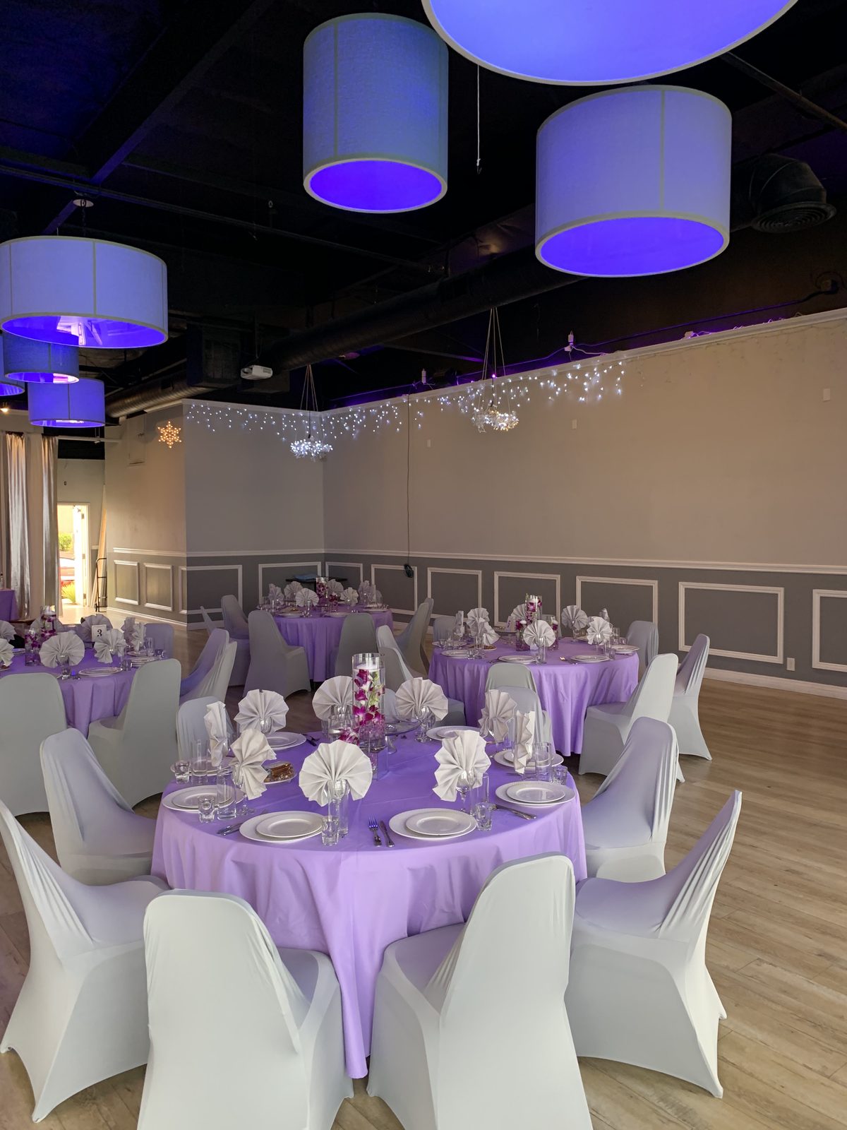 Long table set for a wedding rehearsal dinner in the banquet room